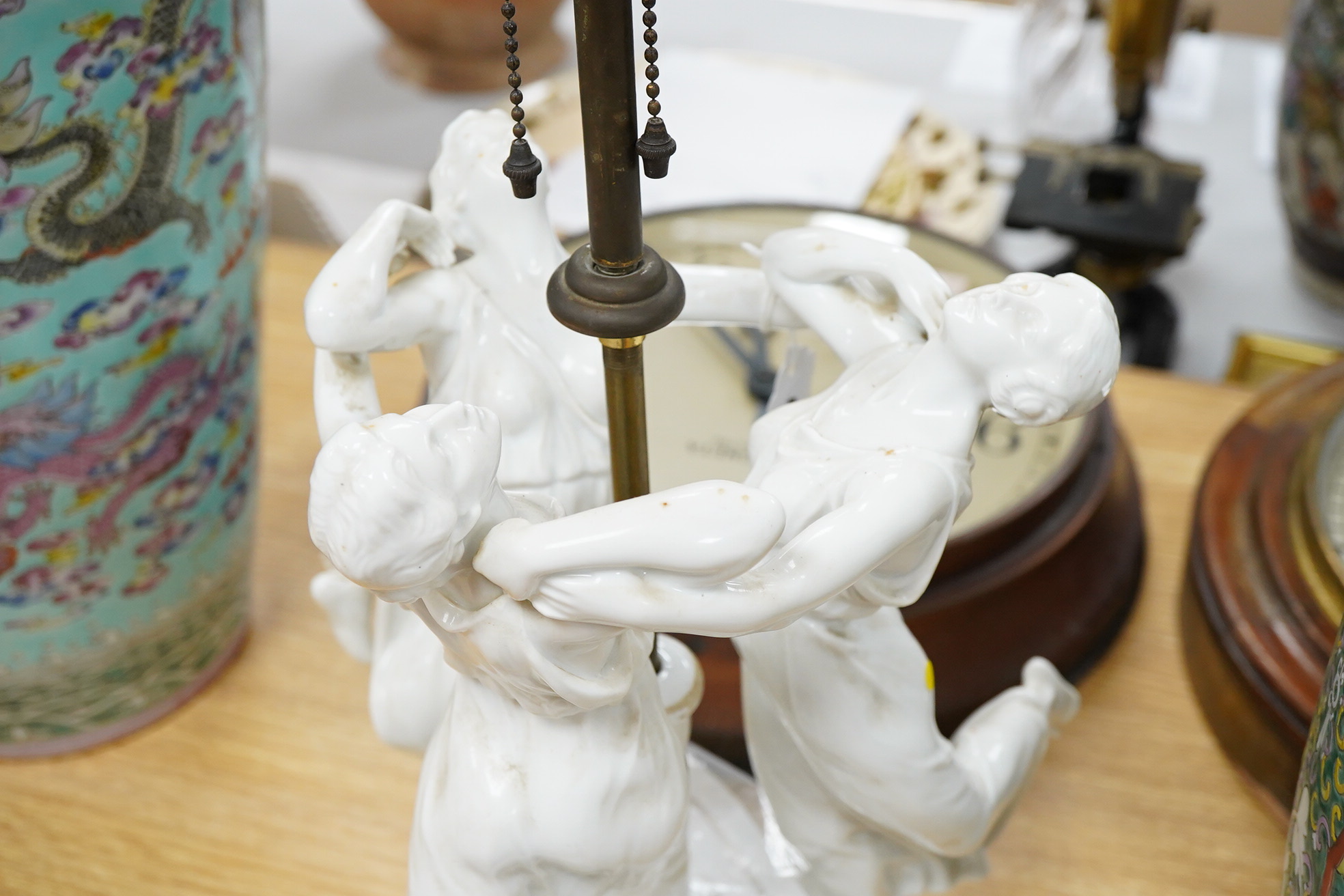 A Rosenthal porcelain 'Three Graces' table lamp, 70cm high overall, old repairs and losses